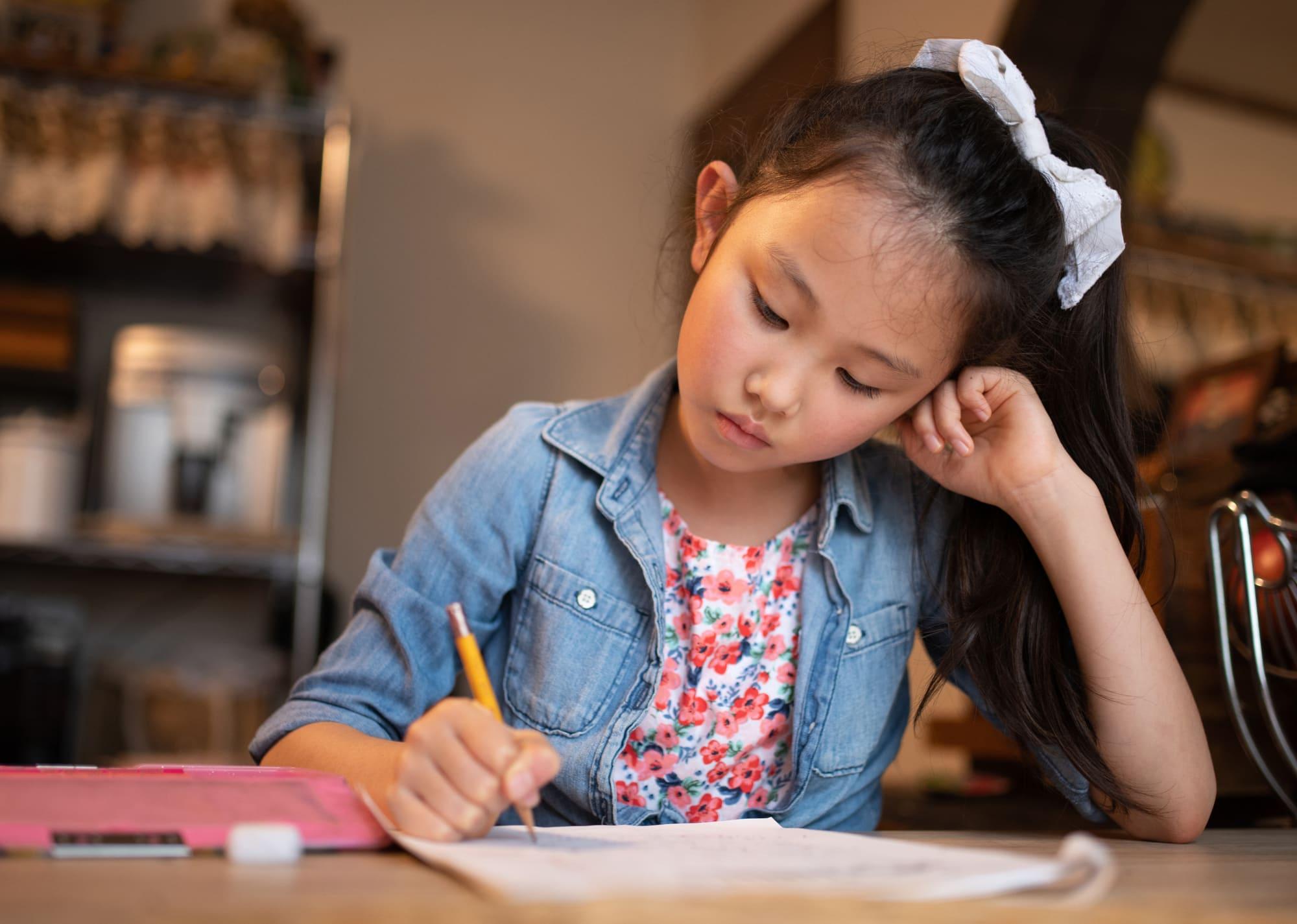 A child working through a practice paper at home