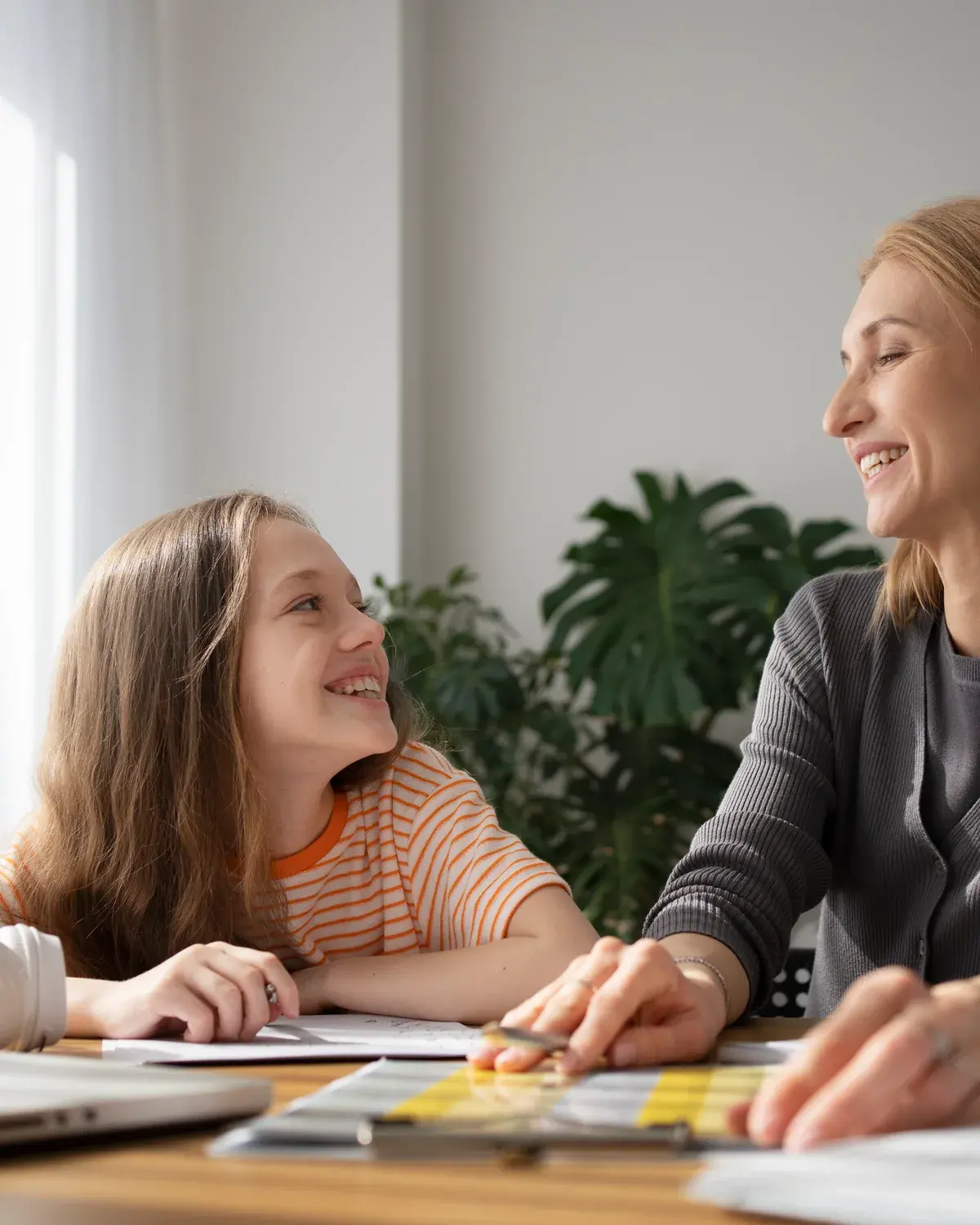 A pupil and tutor laughing together during a lesson